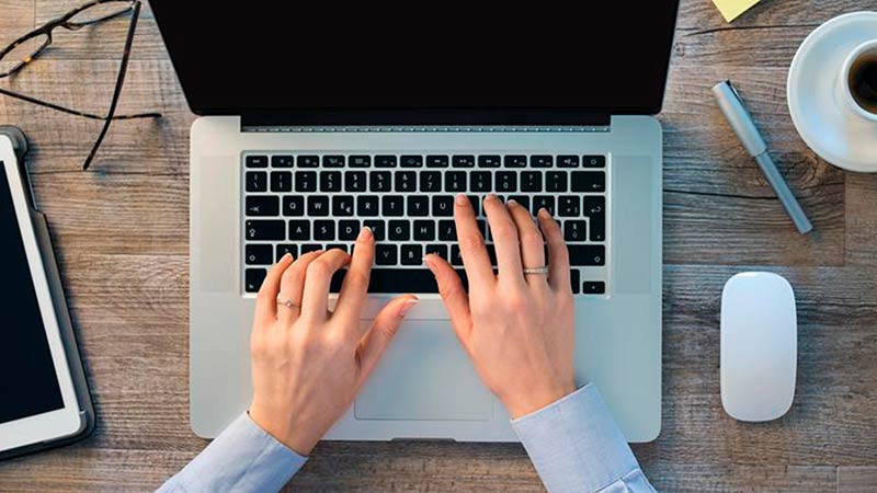 Guy typing on a laptop