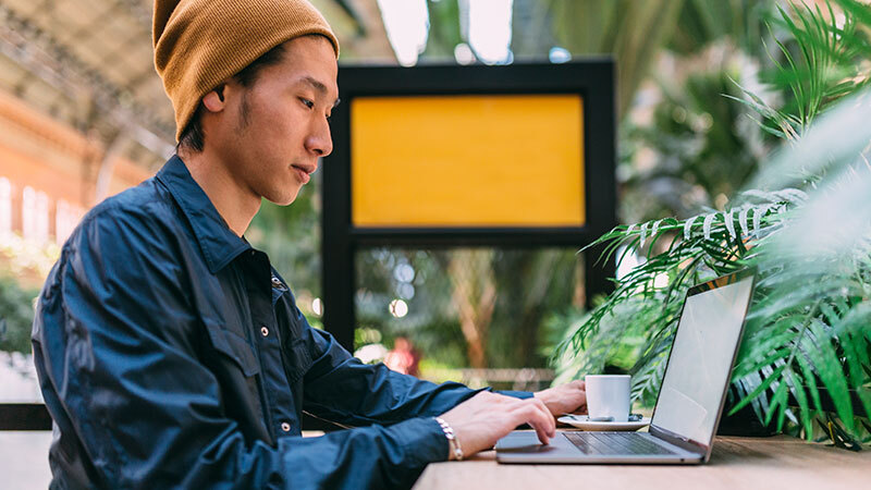 Man with computer drinking coffee